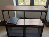 a table with a book on it in front of a window