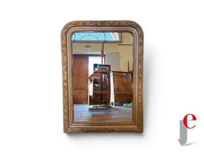 a mirror that has a chair in front of it