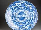a blue and white plate with a circular design on it