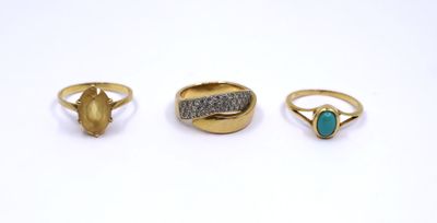 three gold rings and a turquoise stone ring