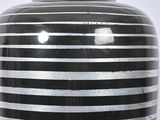 a black and white striped vase sitting on a table