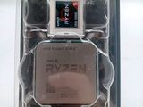 an amd ryzenn processor in its packaging on a white surface