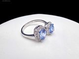 a ring that has two blue stones in it
