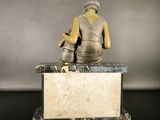 a statue of a woman sitting on top of a marble block