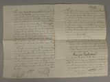 an old piece of paper with writing on it sitting on a table