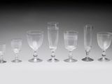 several empty wine glasses are lined up on a table
