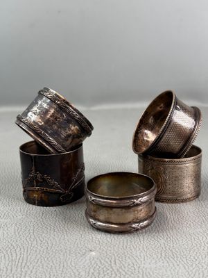 three different types of silver napkins sitting on top of a white surface