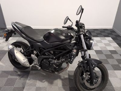 a picture of a motorcycle parked on a checkered floor