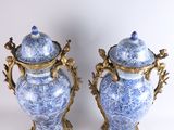 pair of blue and white vases with gold accents on a white background