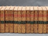 several books are stacked on top of each other on a table