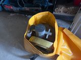 a yellow bag with tools in it sitting on the floor