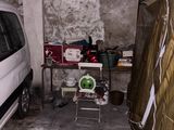 a white van parked in a dirty garage next to a refrigerator