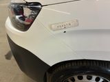 a close up of a white car with a sticker on it