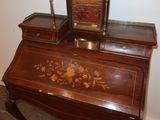 a small desk with a mirror on top of it
