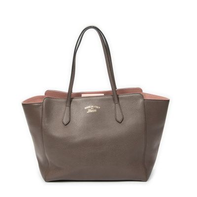 a brown and pink tote bag with two handles