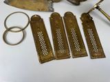 several pieces of brass are sitting on a table next to a pair of scissors and a pair of scissors