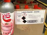 a bottle of liquid sitting next to a cardboard box