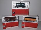 three toy trains sitting on top of each other on a table
