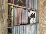 a shelf full of cds and cds in a room