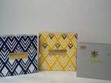 three boxes with different designs on them sitting next to each other