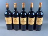 six bottles of red wine lined up in a row