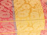 a close up of a pink and yellow floral pattern on a window