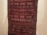 rug hanging on the wall in the corner of a room