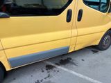 a small yellow van parked in a parking lot