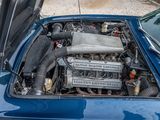 a blue car with an engine in the trunk of it