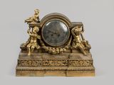 a gold clock that is sitting on top of a table