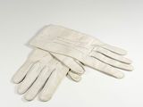 pair of white leather gloves on a white surface
