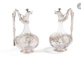 two silver plated vases with handles and handles on a white background
