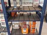 a shelf that has some cans of paint on it