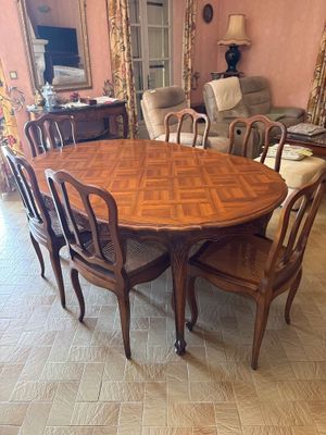 a table and chairs in a room with pink walls