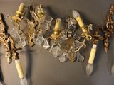 five wall sconces hanging on the wall next to each other