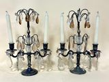 pair of antique black candelabs with crystal drops and candles