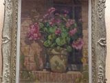 a painting of flowers in a vase on the wall