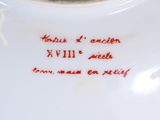 a white plate with a red writing on it