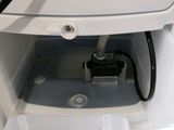 a white washing machine with a basket on top of it
