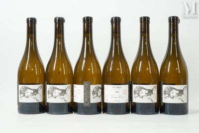 six bottles of wine are lined up in a row on a white surface