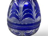 an image of a blue glass egg shaped box on a stand