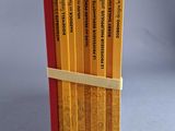 a stack of pencils that have been wrapped in a book