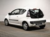 a picture of a small white car parked in a garage