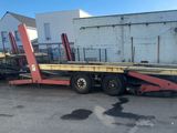 a picture of a flatbed trailer parked in a parking lot
