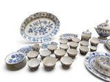 several pieces of blue and white porcelain dishes and bowls on a white surface
