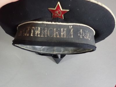 someone is holding a hat with a red star on it