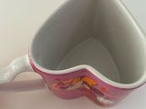 a white bowl with a pink and orange design on it