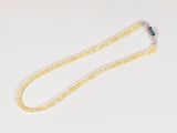 yellow and white beaded necklace with a green flower on a white background