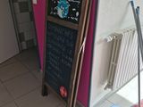 a blackboard with writing on it in the corner of a room