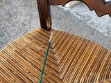 a wooden chair with a green handle on it